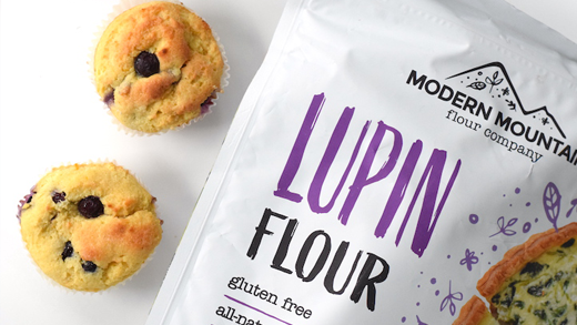 Pouch of lupin flour next to low-carb blueberry muffins