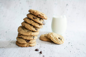 Stack of malted cookies with a glass of milk
