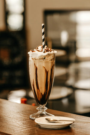 Vanilla malted milkshake topped with whipped cream