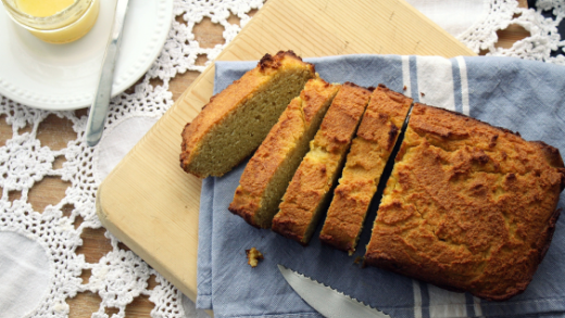 Loaf of low-carb bread made with oat fiber sitting on blue kitchen towel