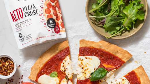 Pieces of keto Pizza next to a pouch of Modern Mountain Keto Pizza Crust