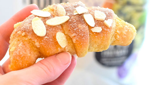 Almond croissant made with lupin flour in front of pouch of Modern Mountain lupin flour