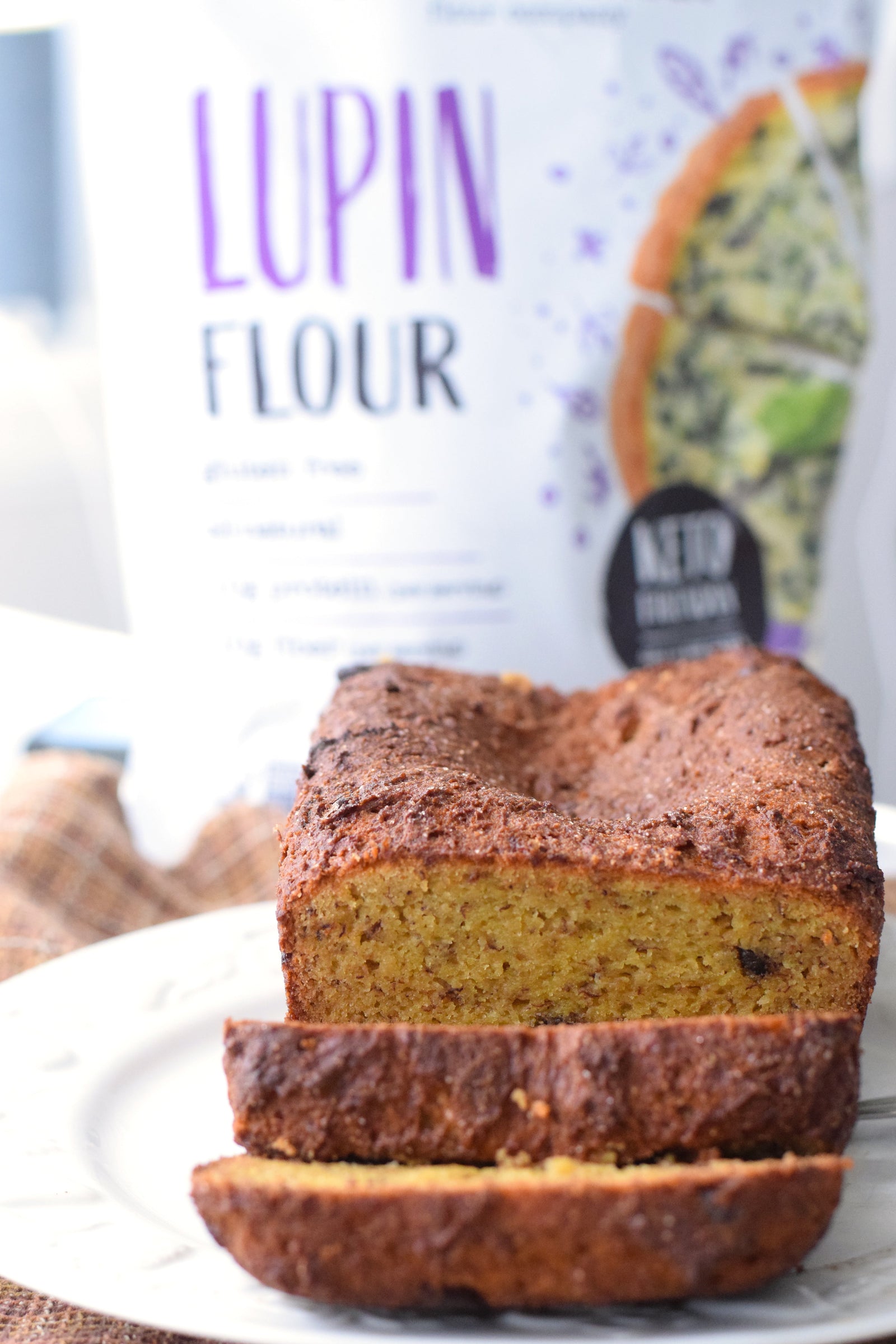 Modern Mountain Lupin Flour pouch beside sliced banana bread