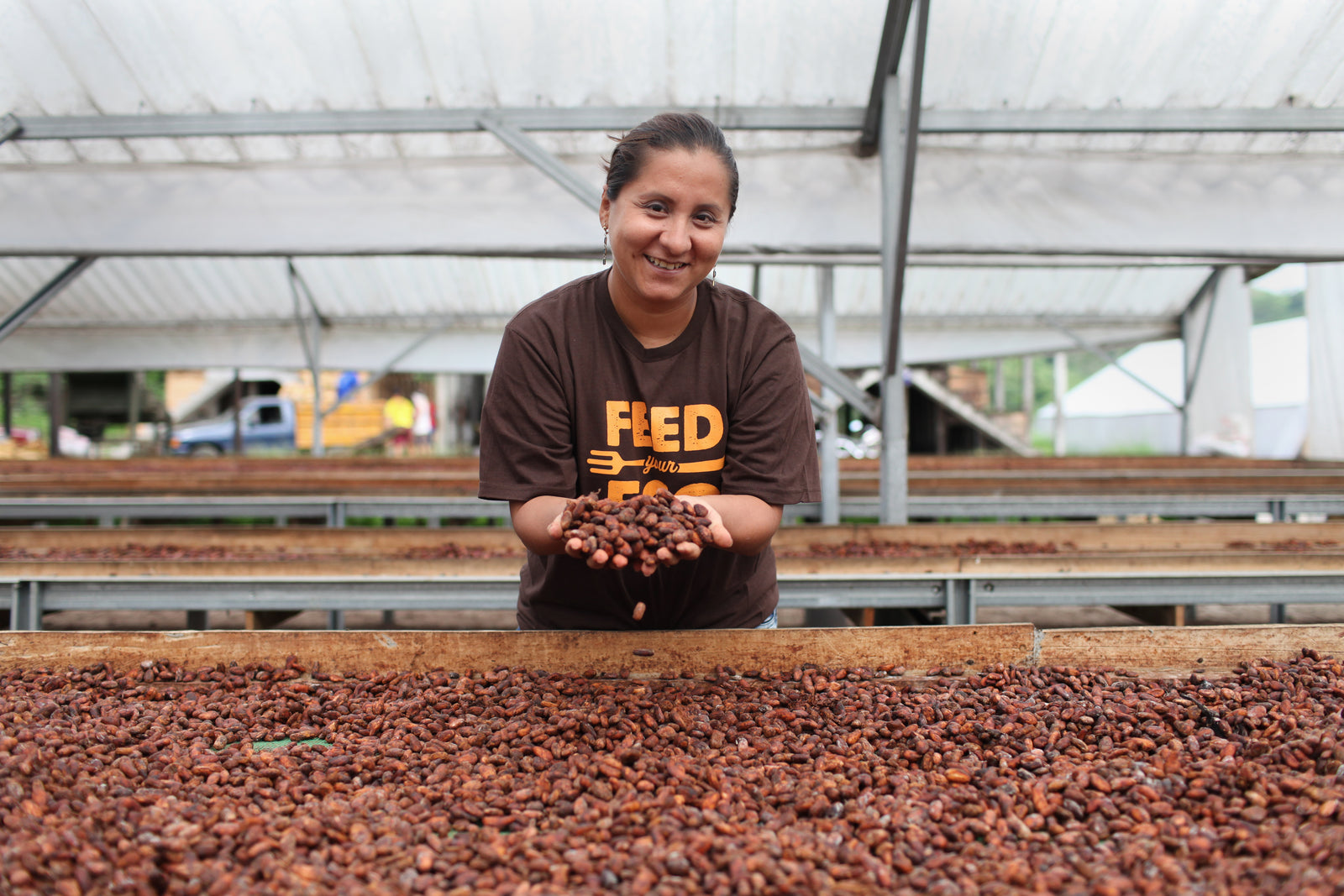 Fair Trade cocoa farmer holding a handful of freshly dried cocoa beans