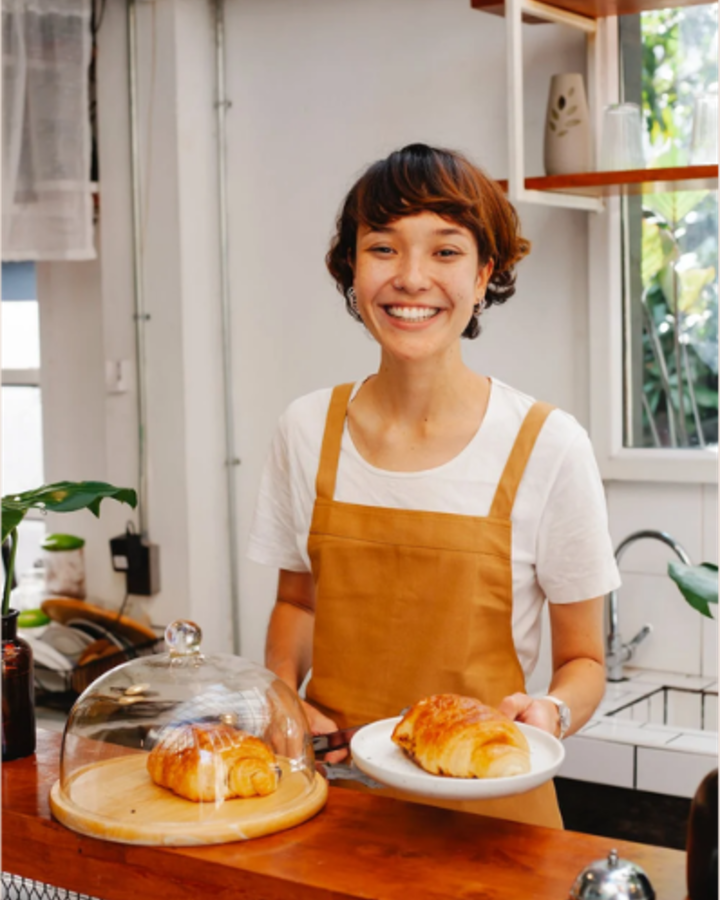 Baker holding a fresh croissant