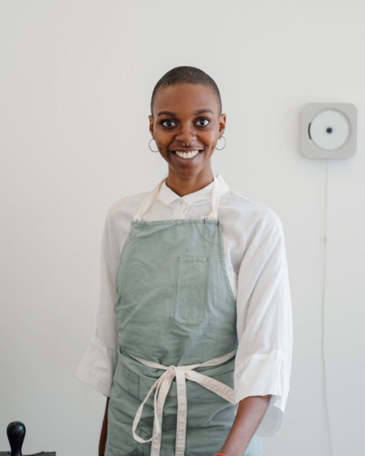 Baker in an apron smiling in the kitchen